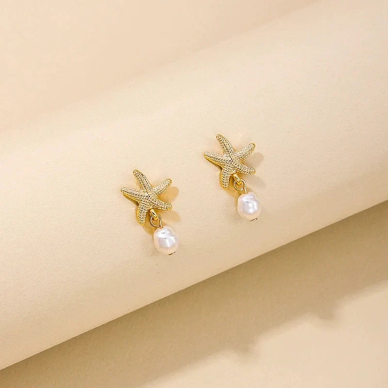 Boucles d'oreilles dorées coquillage étoile de mer et perle