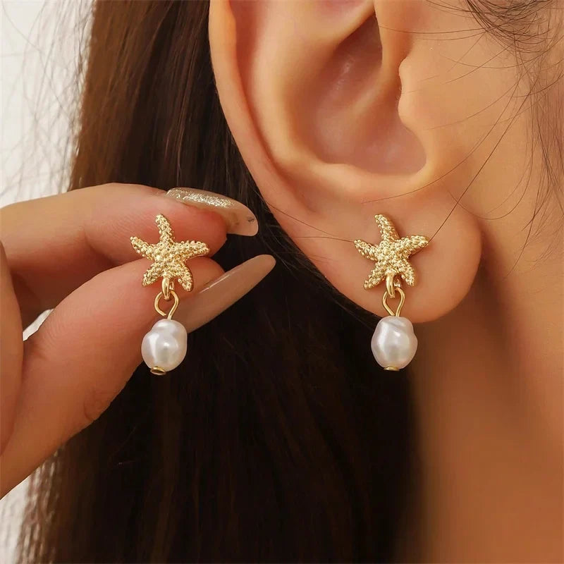 Boucles d'oreilles dorées coquillage étoile de mer et perle
