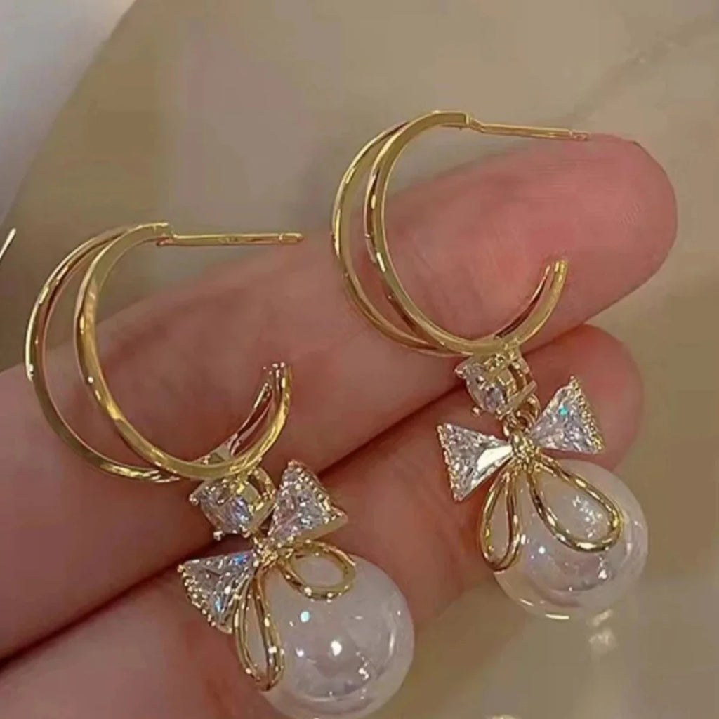 Boucles d'Oreilles Pendantes avec Noeud de Papillon et Perle