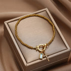 Bracelet avec croix et pierre de naissance