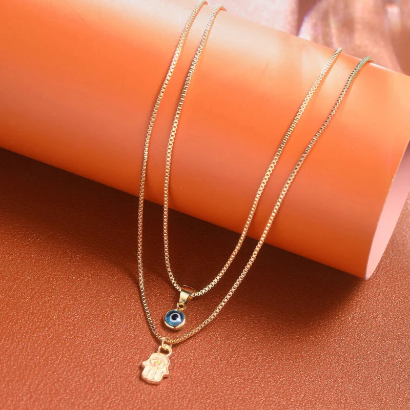Double Necklace with Turkish Blue Eye Pendant and Gold Hamsa Hand