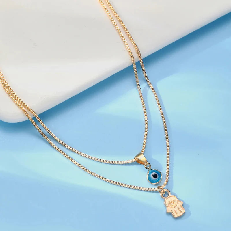 Double Necklace with Turkish Blue Eye Pendant and Gold Hamsa Hand