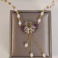 Collier violet à deux cygnes en forme de cœur