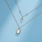 Collier double avec pendentif clef et cadenas argent