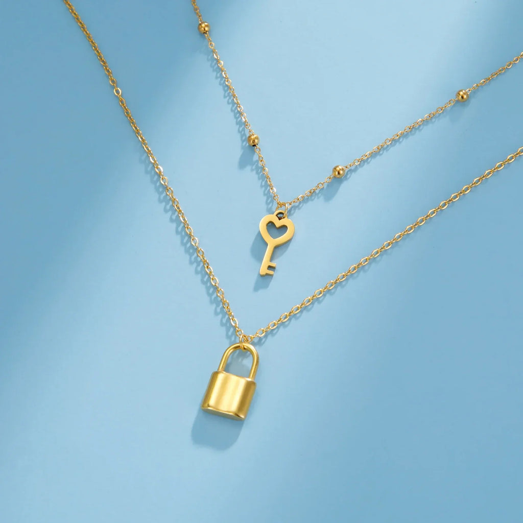 Collier double avec pendentif clef et cadenas or