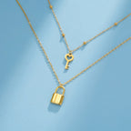 Collier double avec pendentif clef et cadenas or