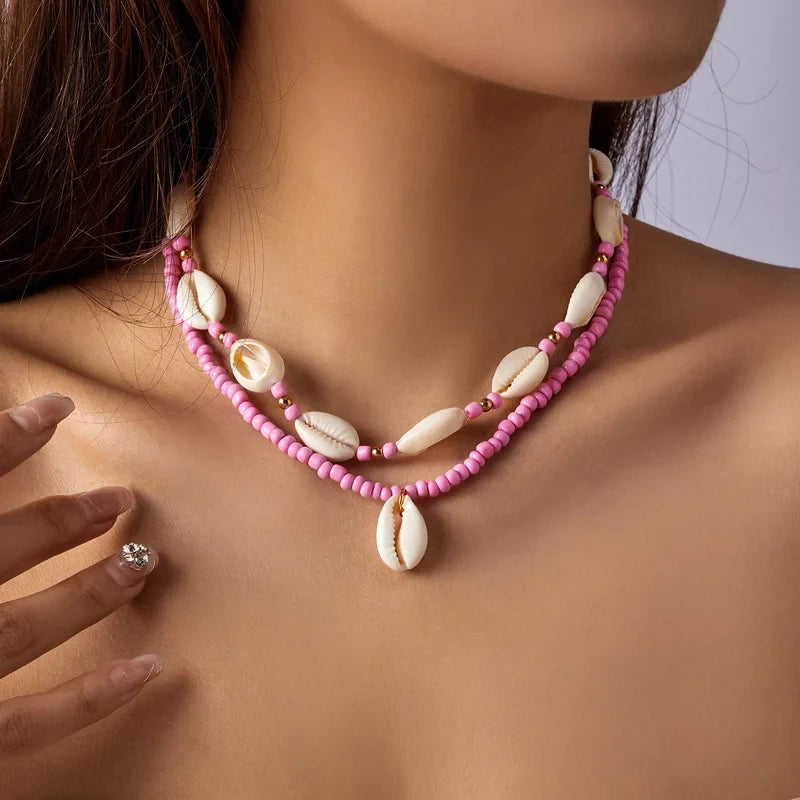 Double collier coquillage cauri rose