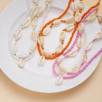 Double collier coquillage cauri rouge