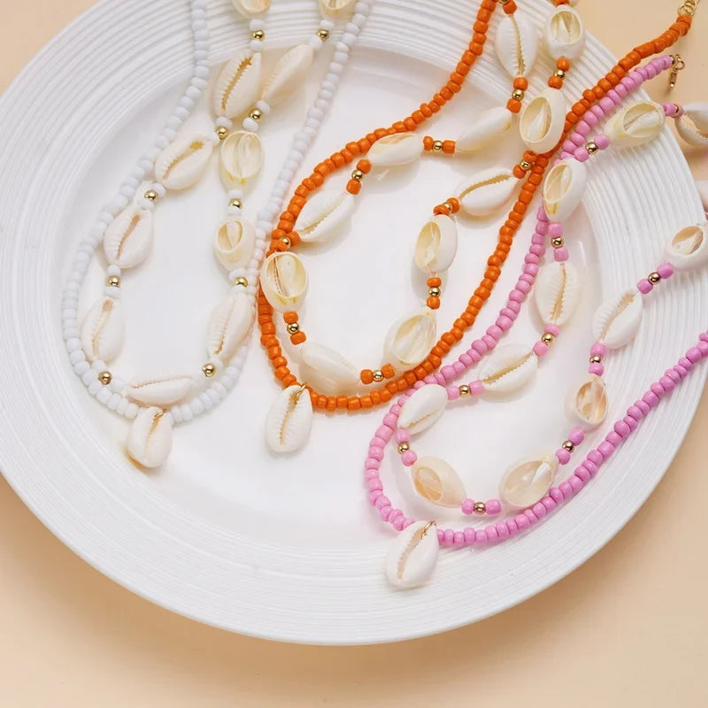 Double collier coquillage cauri rouge