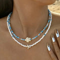 Double collier coquillage et perles colorées bleu tortue