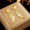 Grandes boucles d'oreilles plume stylisées
