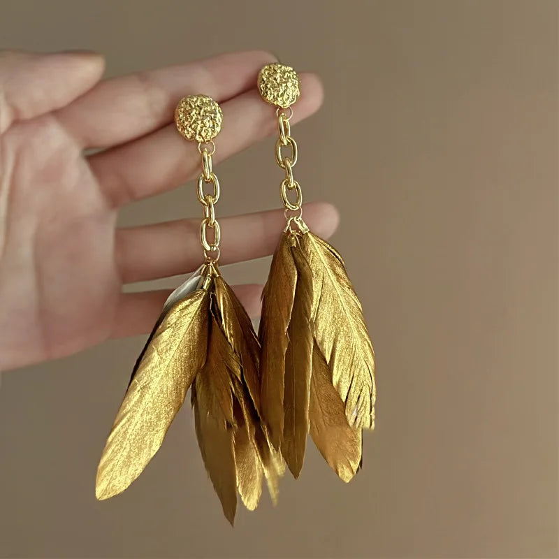 Grandes boucles d'oreilles plumes dorées