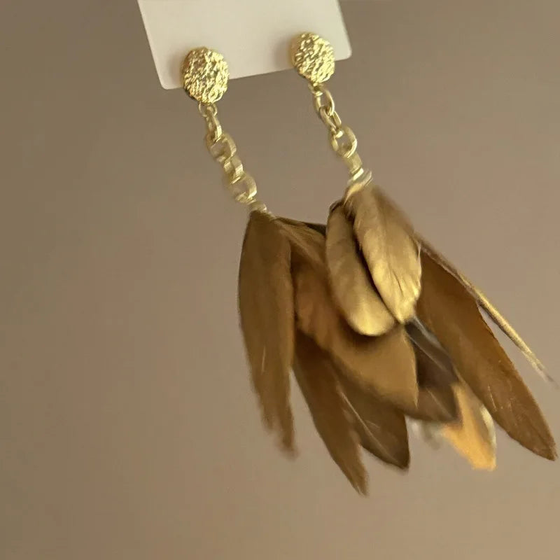 Grandes boucles d'oreilles plumes dorées