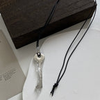 Collier long en corde avec pendentif clef argent brillant