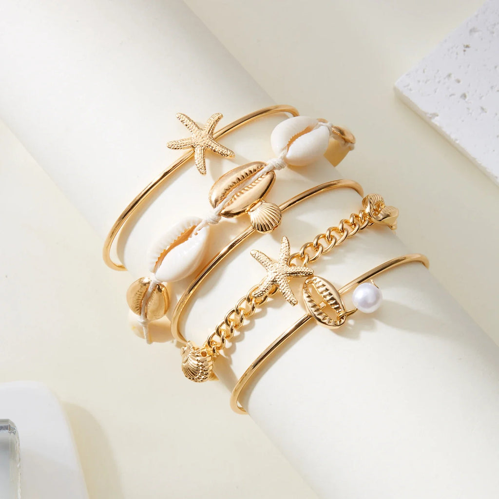Lot de 5 bracelets coquillage et étoile dorés